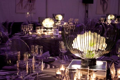 In the dinner tent, illuminated centerpieces included black twig bowls and white amaryllis blossoms.