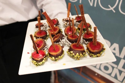 Abigail Kirsch invited attendees to sample its apple-themed dessert items for fall, including these tiny caramel chocolate apples on cinnamon sticks with pistachio cranberry brittle.
