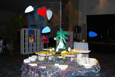 Chef Jonathan Barnett added his own artistic touches to the reception tables, including a rainbow-inspired, paint-splattered black tablecloth and metal module.