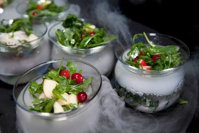 The first course from Jewell Events Catering included the 'Morning Dew Salad.' Served over bowls filled with water and dry-ice capsules, the salads comprised arugula, honey crisp apples, cranberry, goat cheese, and honey-lemon vinaigrette.