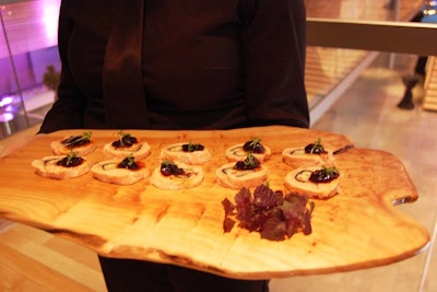 Servers passed hors d'oeuvres like salmon roulade on rustic wood platters.