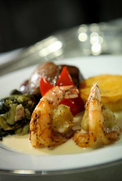 Windows Catering served jumbo crab-stuffed shrimp and roasted tenderloin with red peppers, corn timbale, and panned greens for the main course of dinner.