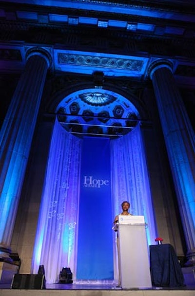 Sheer white draping with blue uplighting was the backdrop for the main podium for the night's speakers.