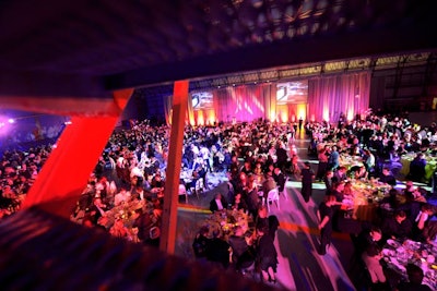 Seven hundred guests attended the gala in the hangar, where draped fabric created a backdrop for the stage.