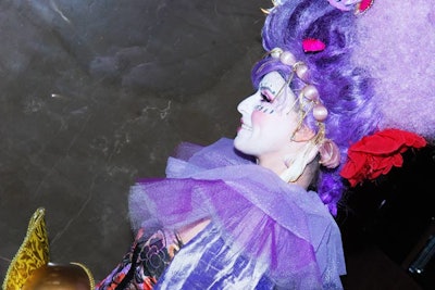 Women dressed in masquerade attire led guests into the ballroom as the night's program began.