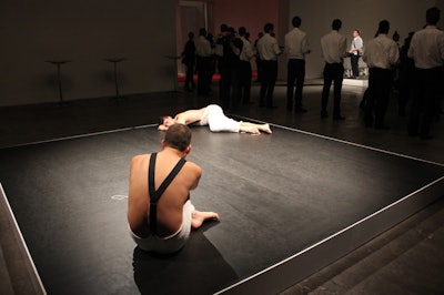 The piece staged in the center of the space involved two men in knit skirts. As the party went on, each performer pulled the yarn from the other's costume.