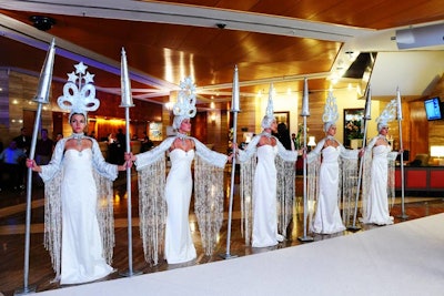 On one side of the white carpet near the entrance, five models were meant to represent stanchions.