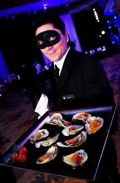 Masked servers offered passed hors d'oeuvres, such as oysters on the half shell.