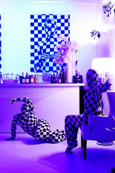 Performers in checkerboard bodysuits mixed among the guests in one of the reception bars.