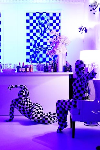 Performers in checkerboard bodysuits mixed among the guests in one of the reception bars.