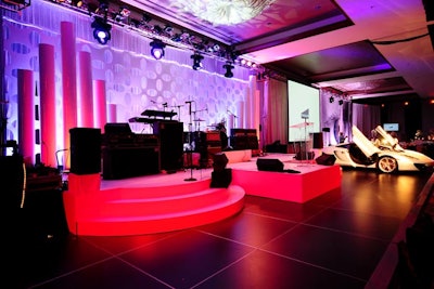 Deco Productions created a white acrylic panel that hung behind the stage. To one side of the stage, the Collection displayed a 2012 McLaren that it donated for the live auction.