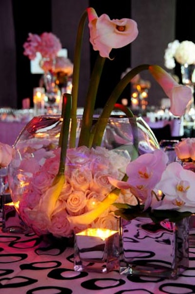 Bayfront Floral Decorators filled glass bowls with white roses and added white calla lilies for height.