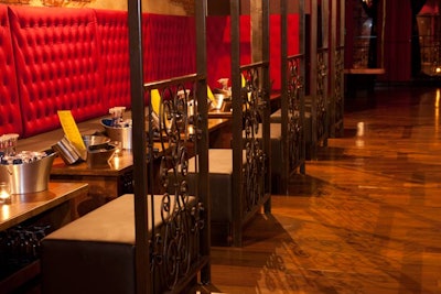 Dirty Bar has tufted red cushions and black leather ottomans along one wall of seating.