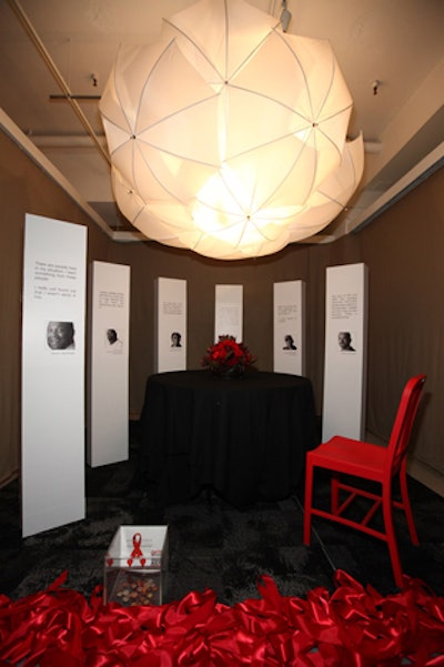 Skender Construction's table, which also had a black, white, and red color scheme, was lit by a fixture made from umbrellas.