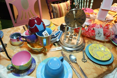 Mismatched teacups, clocks, and playing cards were scattered across the tabletop.