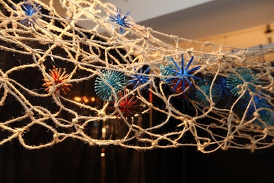 A woven fixture that looked like a fisherman's net filled with colorful sea creatures hung above the table.