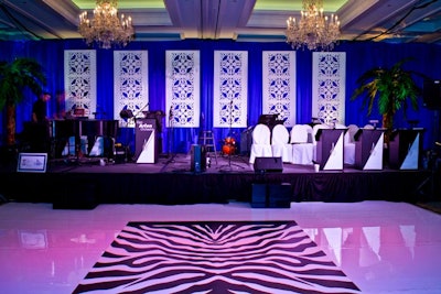 The Ken Arlen Orchestra performed while guests danced on a glossy, patterned floor.