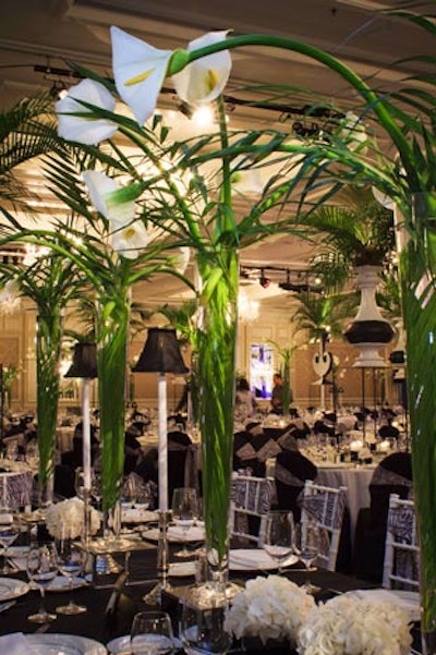 Black lamps, reminiscent of old-school supper clubs, decorated tables along with flower arrangements.