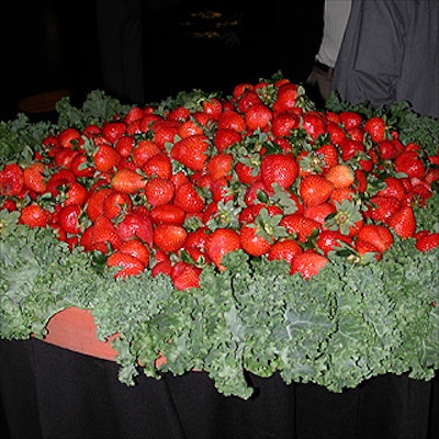 A large table of fresh strawberries by caterer Marjorie Wilson of Marjorie's provided dramatic contrast to the green vegetables and shrouds of green material.