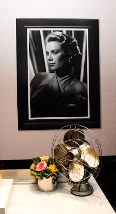 The TIFF team created vignettes to channel the 1950s. They hung Grace Kelly's head shots on the wall to mimic a greenroom and used an antique fan as a prop.