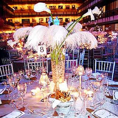 Color of Magic's dinner decor included clear glass vases filled with stones, water, white calla lilies and white feathers.