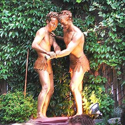 Patrick Trettenero posed actors done up as bronze gods in combat poses against the ivy-covered wall in the garden of the Merchant's House Museum.