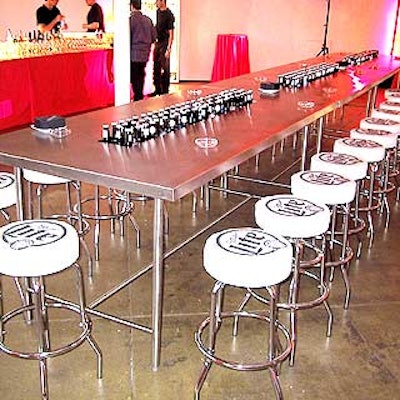 To promote one of the event's sponsors, long metal tables had troughs of ice in the center filled with chilled bottles of Miller Lite, and its stools had covers branded with the beer's logo.