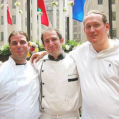 James Barry (left) and Michael Oppizzi (right) of Oppizzi Designs and Michael Stone of Millennium Catering created the giant cake.