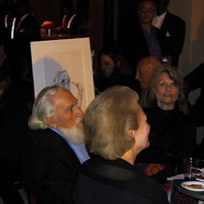 Renowned Broadway caricaturist Al Hirschfeld sat at a table with his family members—including his daughter, Nina, whose name appears in his drawings—while receiving a birthday salute from ArtsConnection.