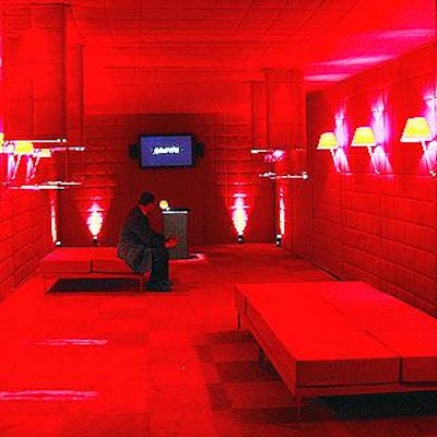 In a rich, red room, Louis Vuitton watches were displayed in Plexiglas boxes suspended from the ceiling.
