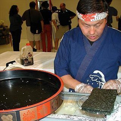 Sushi chef Henry Yamada from Oshiso Company served sushi at the DigitalHome Experience show.