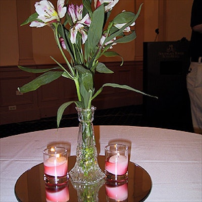 The table centerpieces by the SouthGate Tower Suite Hotel used mirrors to show off the vases of flowers.