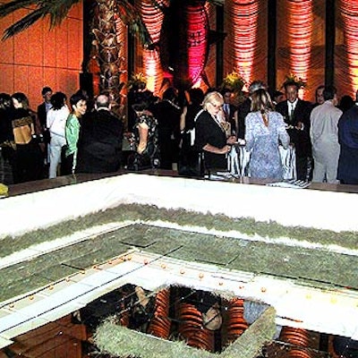 The restaurant's pool was covered in mirrored tiles and John Nyomarkay from Pulp Design created a mobile with red compass-shaped pieces hanging from the ceiling over it.