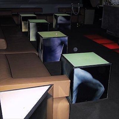 IBM decorated Spa with illuminated lucite cube cocktail tables showing advertising images.