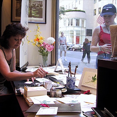 Calligrapher Maria Thomas of Pendragon Ink Limited inscribed pen and ink works for shoppers and caught the attention of people passing by the new Crane & Company store in Rockefeller Center.