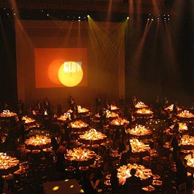 The dining area on the main floor of the Hammerstein Ballroom was washed with warm yellow lights by Bernhard-Link Theatrical.