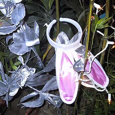 For the party's enchanted forest theme, production company Toast decorated fake foliage with bunny ears, lights, silver butterflies, silver silk flowers and mini silver disco ball ornaments.