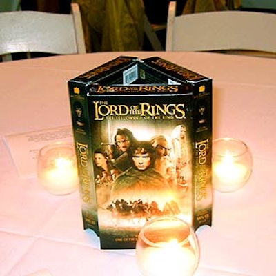 White cloths covered the tables, and white votive candles and videocassette boxes of the movie served as cheapie centerpieces.
