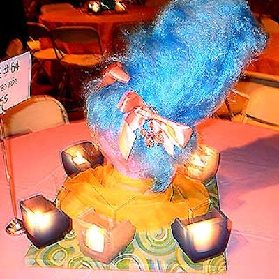 Tables were covered with colored cloths and topped with whimsical wigs, hairpieces and kitschy votive candle holders in the shape of 1960's-era TVs.