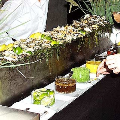 Tentation's sleek, bilevel oyster bar made of stainless steel was covered with crushed ice, oysters and five dipping sauces.