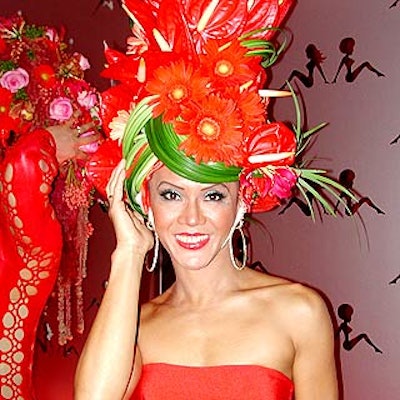 A scantily clad model topped with a tall floral headdress welcomed guests into the party.