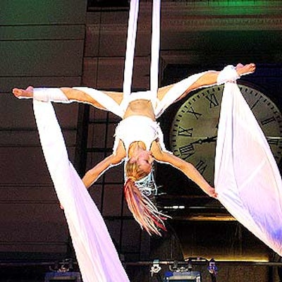 At Macy's Remember Me to Herald Square celebration, a fabric aerialist from Antigravity performed above the stage rigged in front of Macy's Broadway entrance.