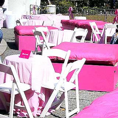 Large pink bed seats and white tables with pink gingham tablecloths surrounded the stage in the V.I.P. area.