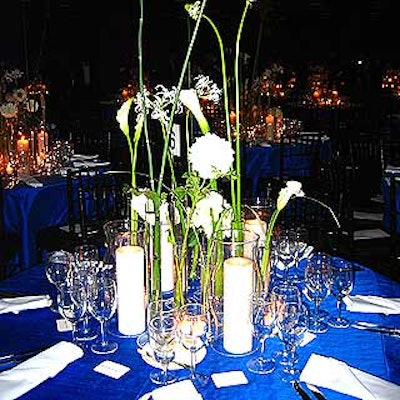 At the Municipal Art Society's annual benefit at the American Museum of Natural History, Robert Isabell's table decor included ivory pillar candles in hurricane vases and eight white single-stem flowers inside tall, slender bud vases atop royal blue shantung silk tablecloths.