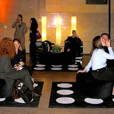 Creative Edge Parties created a black and white lounge with polka-dot carpets and black leather chairs and ottomans.