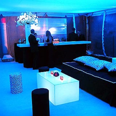 A tented after-party area was lit with black light by Stortz Lighting—giving a glowing effect to the white bar and large black sofas topped with black-and-white satin pillows.