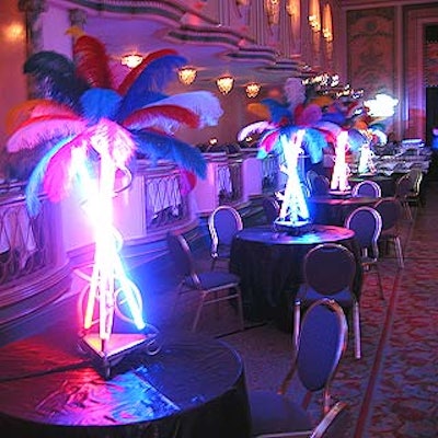 The dinner's colorful centerpieces used neon lights and brightly colored feathers.