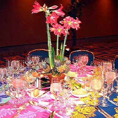 Dinner tables were covered with multicolored tropical fabrics and potted amaryllis centerpieces from ZeZe Flowers.