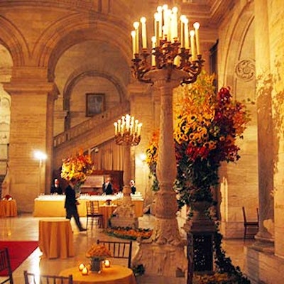 Large candelabras and lush sunflower, branch and leaf arrangements filled Astor Hall for the cocktail hour.