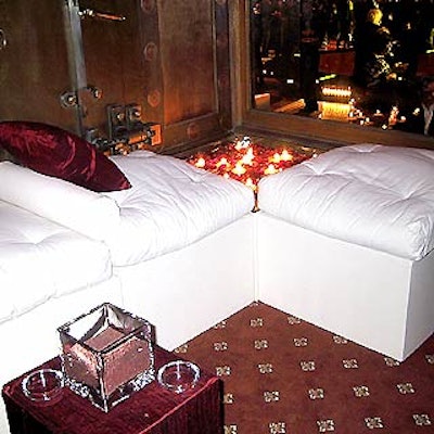 In the V.I.P. areas, designer Antony Todd used white canvas ottomans adorned with crimson raw silk pillows and giant square boxes made of clear Lucite that held water, red rose petals, and floating candles.